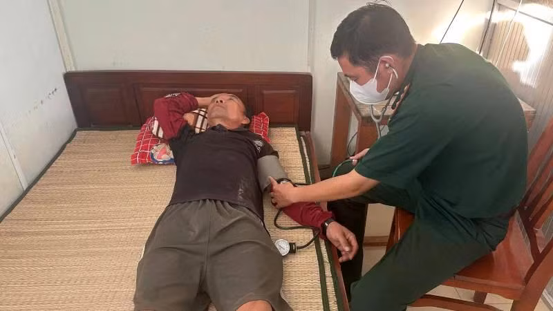 Bác sĩ Đồn Biên phòng Hàm Luông kiểm tra sức khỏe thuyền viên. (Ảnh: HOÀNG TRUNG)