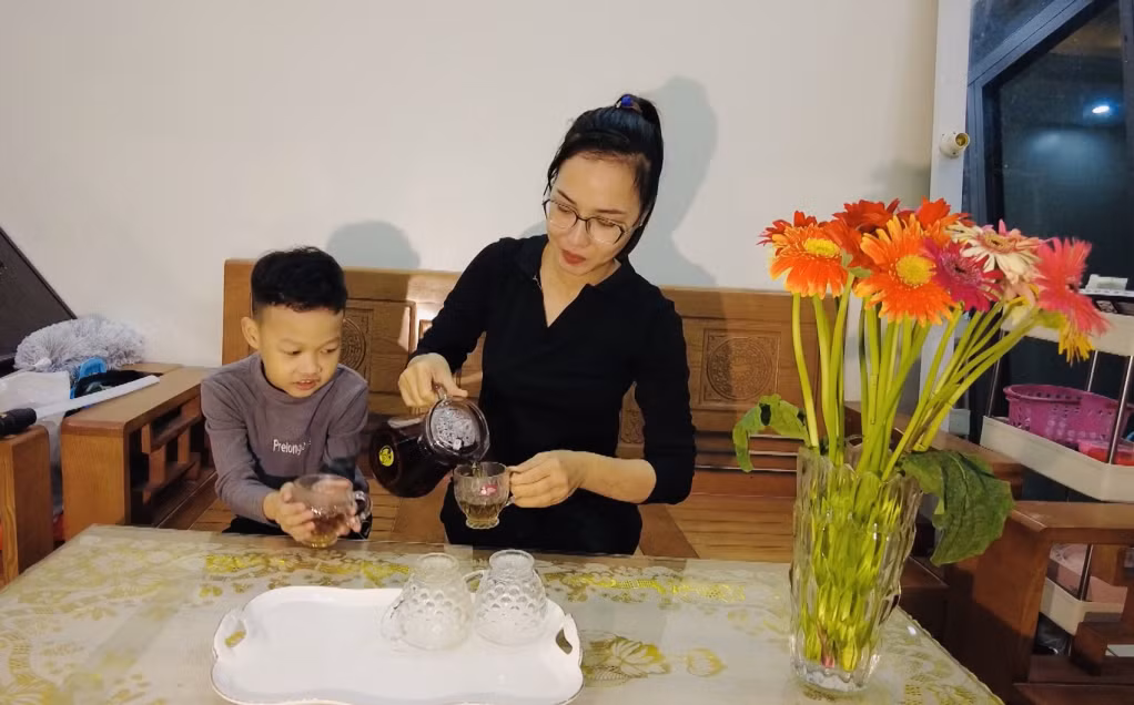 Mẹ con chị Nguyễn Thị Thanh Vui trong căn nhà mới do Công ty CP Than Mông Dương hỗ trợ xây dựng.