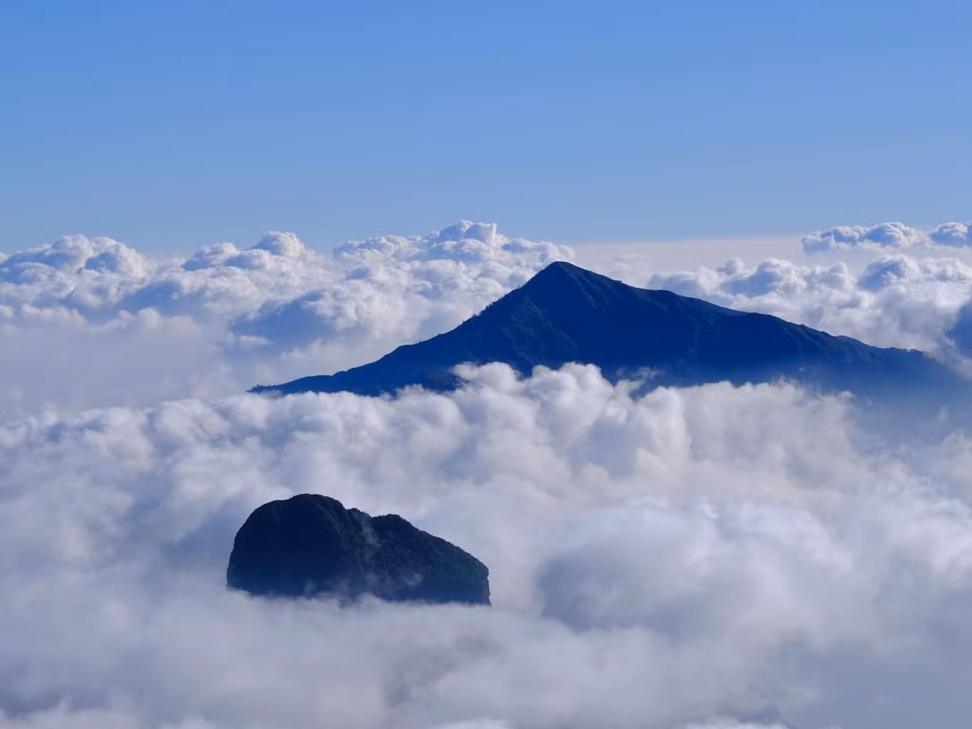Ở độ cao 2.965 m so với mực nước biển, tên "Nhìu Cồ San" trong tiếng H'Mông có nghĩa là "sừng trâu", gợi hình ảnh hai đỉnh núi nhô cao uốn cong như chiếc sừng khổng lồ. Ảnh: Gió