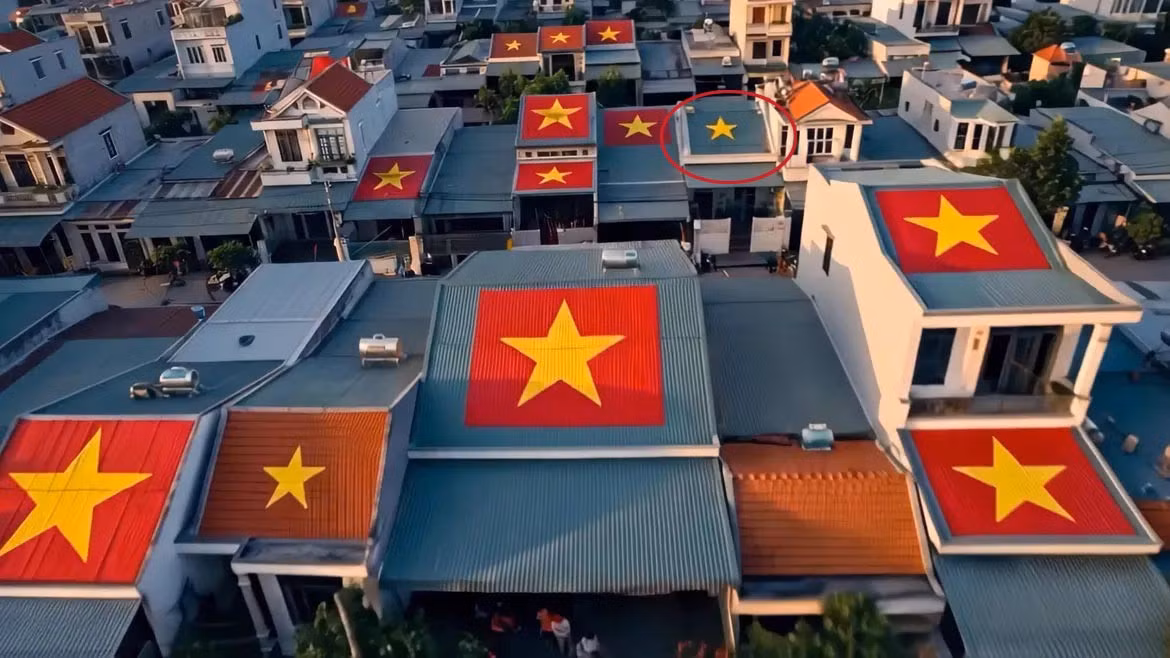 Lỗi trong việc dùng AI tạo dựng hình ảnh cờ đỏ trên mái nhà (phần khoanh đỏ). Ảnh: Chụp từ MV