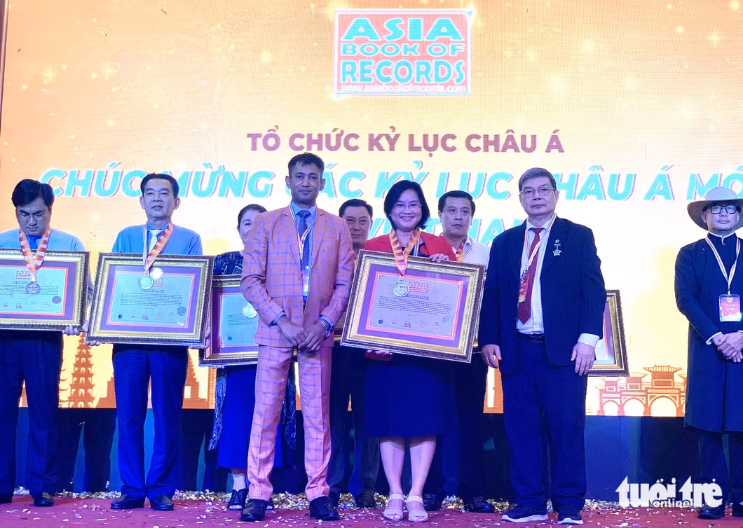 Đại diện Đồng Tháp nhận kỷ lục châu Á về các món ăn từ sen - Ảnh: KHUÊ NGUYÊN