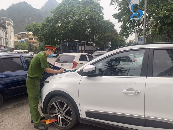 Công an phường Bạch Đằng (TP Hạ Long) lập biên bản xử lý phương tiện dừng, đỗ không đúng nơi quy định.