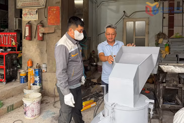Ông Đinh Văn Giang (bên phải) giới thiệu các sản phẩm do mình sáng chế.