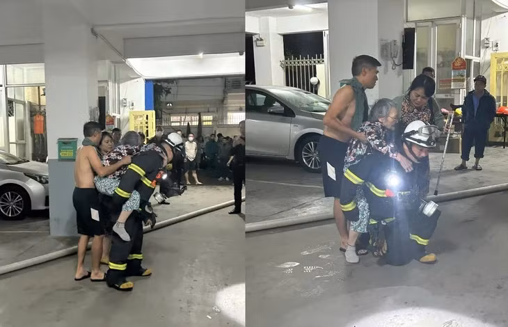Cảnh sát cứu nạn hai người khỏi tòa chung cư xảy ra hỏa hoạn - Ảnh: THÀNH NAM
