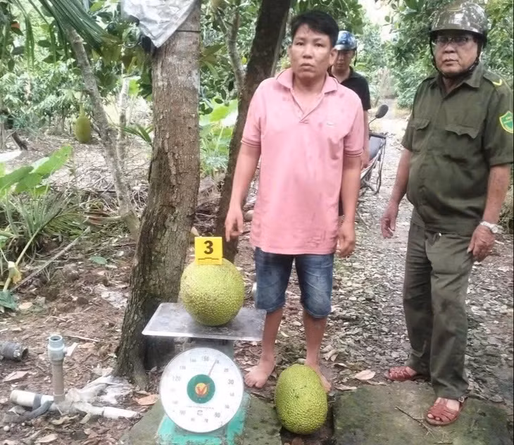 Bị can Lê Hoàng Lợi cùng tang vật 2 trái mít - Ảnh: CACC