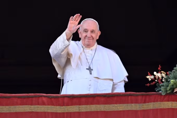 Giáo hoàng Francis vẫy tay từ ban công chào đám đông tập trung dưới Quảng trường St.Peter ở Vatican ngày 25/12. Ảnh: AFP.
