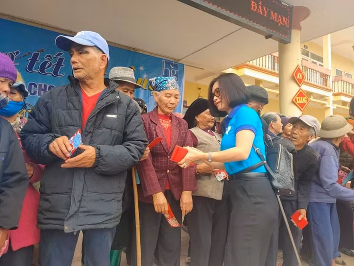 Chị Phạm Thị Hồng Ngân, Phó Chủ nhiệm Câu lạc bộ thiện nguyện Nhân Ái Móng Cái, mừng tuổi các cụ già tại "Chợ Tết 0 đồng" năm 2021.