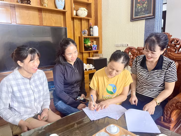Các thành viên Tổ vay vốn Ngân hàng Chính sách xã hội do bà Nguyễn Thị Thuyên làm Tổ trưởng ký sổ đóng lãi hằng tháng.