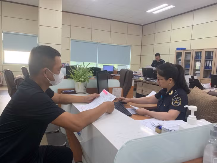 Cán bộ Chi cục Hải quan cửa khẩu Móng Cái hướng dẫn doanh nghiệp thực hiện các thủ tục thông quan hàng hóa. Ảnh do đơn vị cung cấp