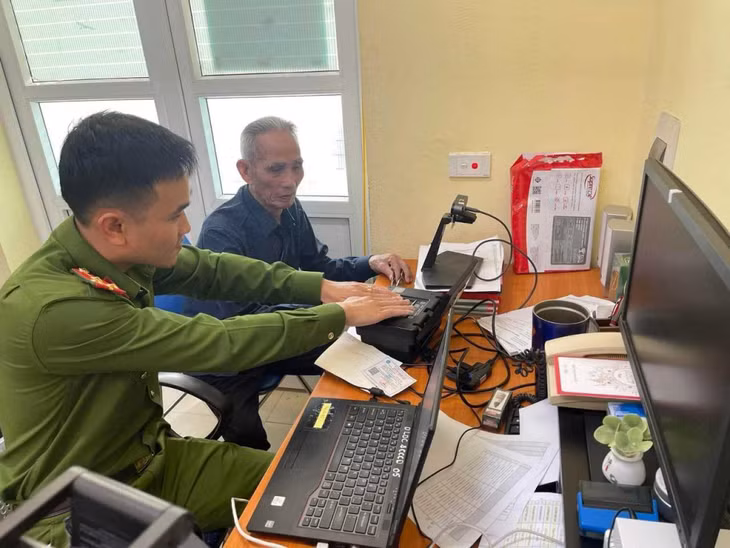 Công an huyện hướng dẫn người dân kích hoạt tài khoản định danh điện tử. Ảnh: Thanh Tùng (Trung tâm TT-VH Vân Đồn).