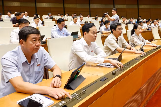 Đại biểu Quốc hội ấn nút biểu quyết thông qua các dự án Luật. (Ảnh: TTXVN)