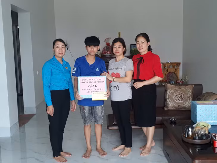 Chị Hà Thị Loan, Trưởng Ban Nữ công Công ty CP Than Mông Dương (ngoài cùng bên trái) thăm, tặng quà Tết thiếu nhi cho con công nhân Công ty.