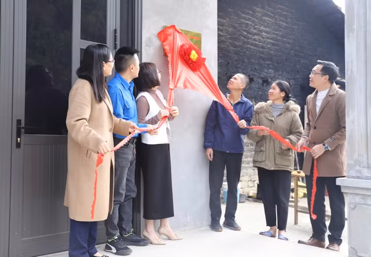 Các đại biểu kéo băng khánh thành và bàn giao nhà "Đại đoàn kết" cho gia đình anh Ma Đức Sơn (khu Pắc Liềng, thị trấn Bình Liêu, huyện Bình Liêu).