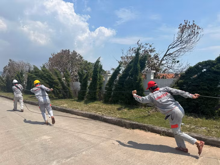 Nhân viên Viettel Quảng Ninh cùng lực lượng hỗ trợ kéo dây cáp từ trạm chính đến các trạm nhánh tại phường Tuần Châu (TP Hạ Long).