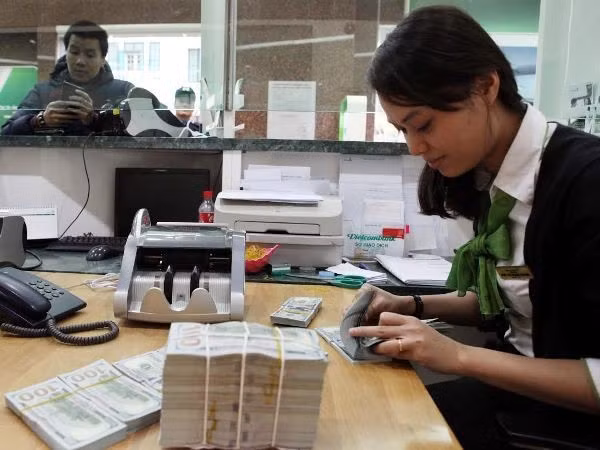 Ngân hàng Nhà nước lý giải nguyên nhân tỷ giá tăng khi USD thế giới giảm. (Ảnh: Vietnam+)