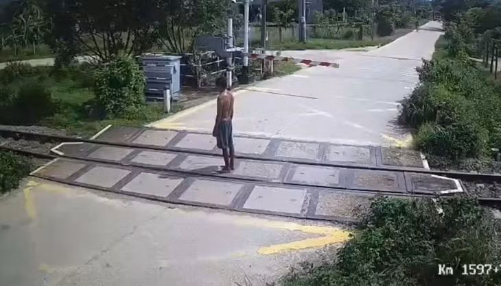 Người đàn ông đứng im trên đường ray. (Hình ảnh cắt từ clip)
