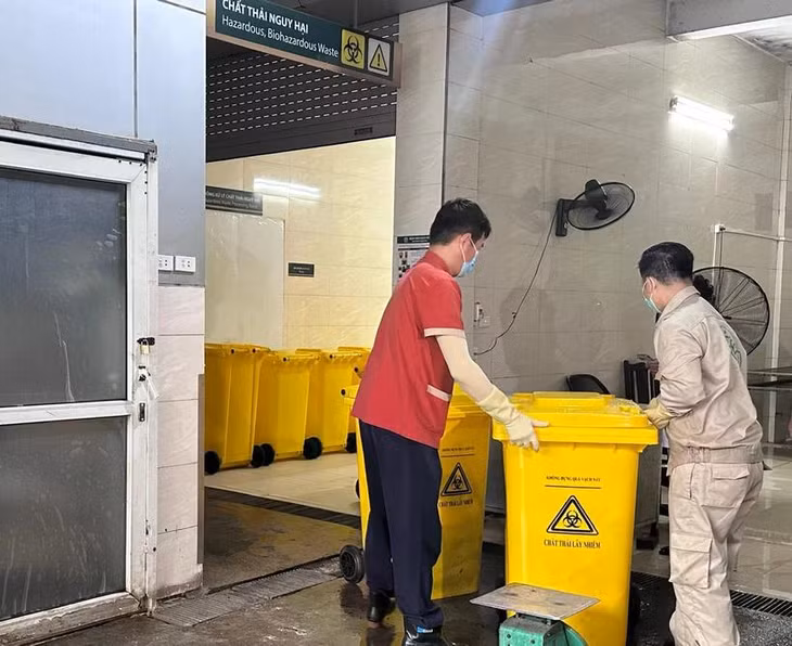 Nhân viên làm công tác xử lý chất thải y tế nguy hại tại Bệnh viện Bạch Mai. (Ảnh: PV/Vietnam+)