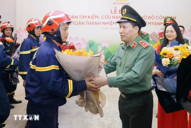 Trung tướng Lê Văn Tuyến, Thứ trưởng Bộ Công an tặng hoa chúc mừng cán bộ, chiến sỹ đoàn tìm kiếm, cứu nạn và cứu hộ Bộ Công an hoàn thành nhiệm vụ trở về từ Myanmar. (Ảnh: Phạm Kiên/TTXVN)