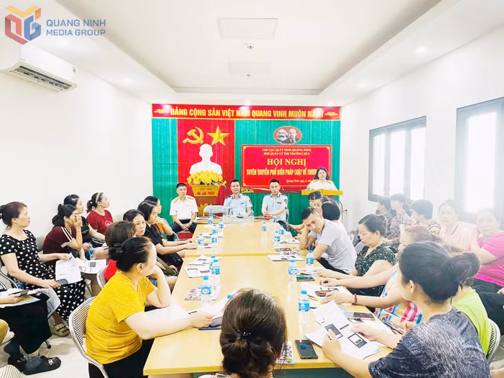 Cán bộ QLTT và Ngành thuế phối hợp tuyên truyền, phổ biến chính sách thuế cho các hộ kinh doanh trên địa bàn.