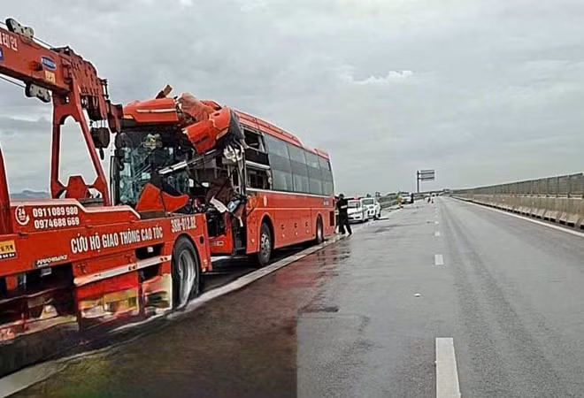 Hiện trường tai nạn khiến xe khách hỏng nặng phần đầu, xe cứu hộ đến kéo đi để giải phóng ách tắc. Ảnh: Đức Tuấn.