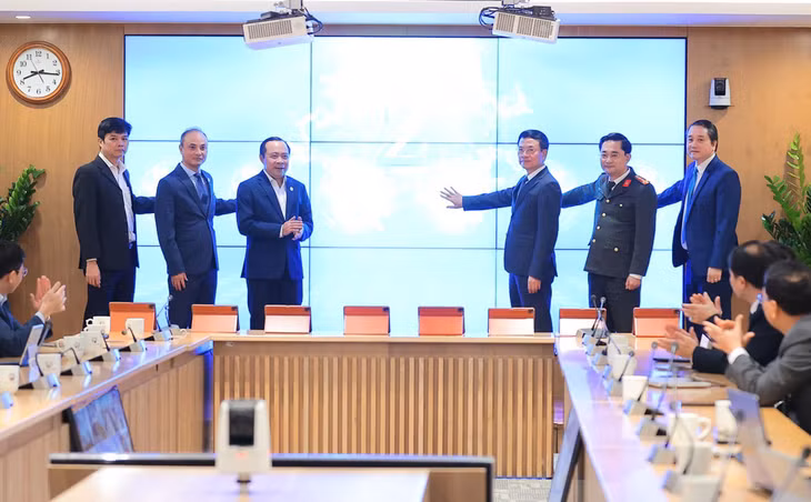 Các đại biểu thực hiện nghi thức bấm nút khai trương hệ thống. Ảnh: Hạo Thiên