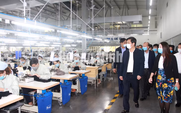 Chủ tịch UBND tỉnh Nguyễn Tường Văn kiểm tra hoạt động sản xuất tại Công ty TNHH May mặc Hoa Lợi Đạt (2-2021). Ảnh: Mạnh Trường