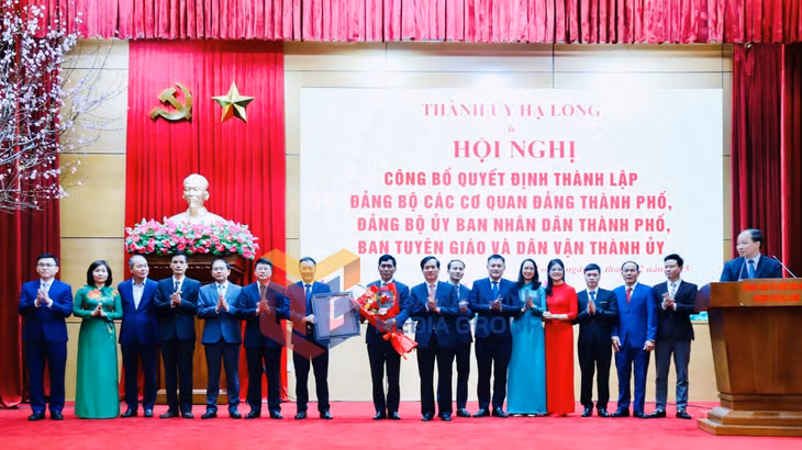 Đồng chí Vũ Quyết Tiến, Ủy viên Ban Thường vụ Tỉnh ủy, Bí thư Thành ủy Hạ Long trao Quyết định và tặng hoa chúc mừng Đảng bộ UBND thành phố (2-2025). Ảnh: Hoàng Nga