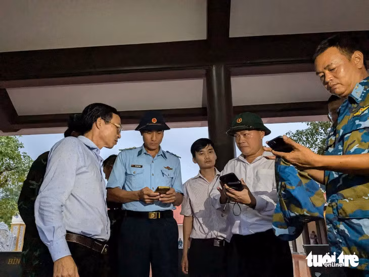 Ông Phan Chí Hùng (thứ 2 từ phải qua) chia sẻ thông tin tọa độ của phi công Quân với lực lượng tìm kiếm - Ảnh: TẤN LỰC