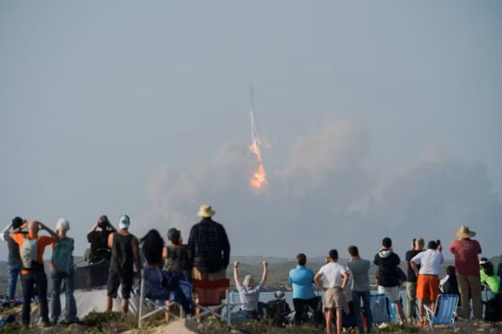 Nhiều người dân đứng từ xa hò reo khi ban đầu tên lửa Starship được phóng thành công. Ảnh: Reuters.