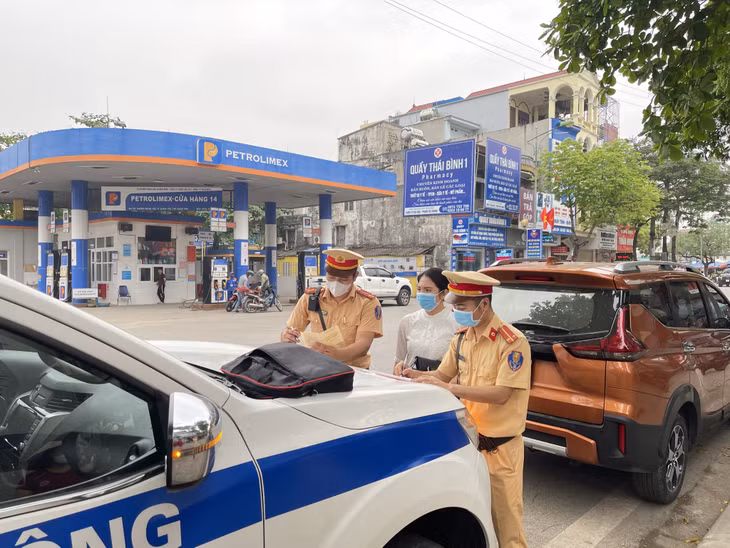 Lực lượng CSGT Công an TX Quảng Yên lập biên bản vi phạm đối với chủ phương tiện dừng, đỗ sai quy định.