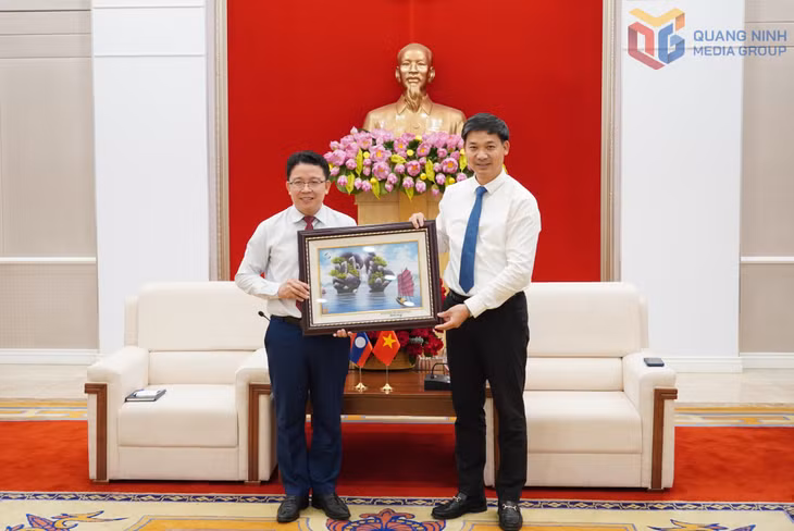 Đồng chí Phó Chủ tịch UBND tỉnh Quảng Ninh trao quà lưu niệm cho đồng chí Phó Giám đốc Học viện Chính trị - Hành chính quốc gia Lào.