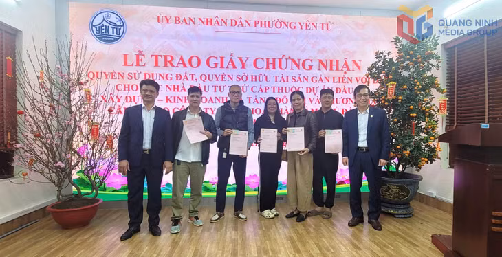 Đại diện UBND phường Yên Tử, Văn phòng Đăng ký đất đai tỉnh trao giấy CNQSDĐ cho các hộ dân.