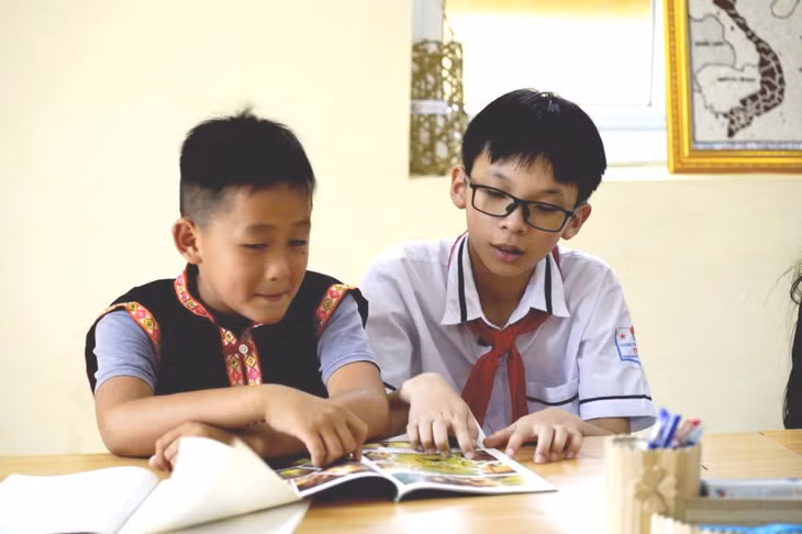 Triệu Đức Duy đọc sách cùng bạn học sinh vùng cao. Ảnh: Nhân vật cung cấp