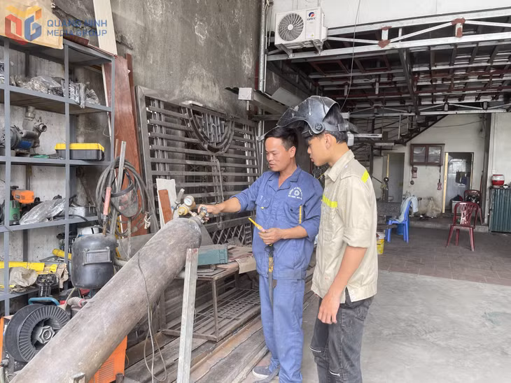 Anh Nguyễn Văn Hiếu, khu Yên Dưỡng, phường Hoàng Quế hướng dẫn thợ sử dụng thiết bị cơ khí.