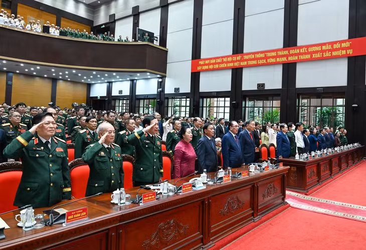 Các đại biểu tham dự Đại hội thực hiện nghi thức chào cờ.