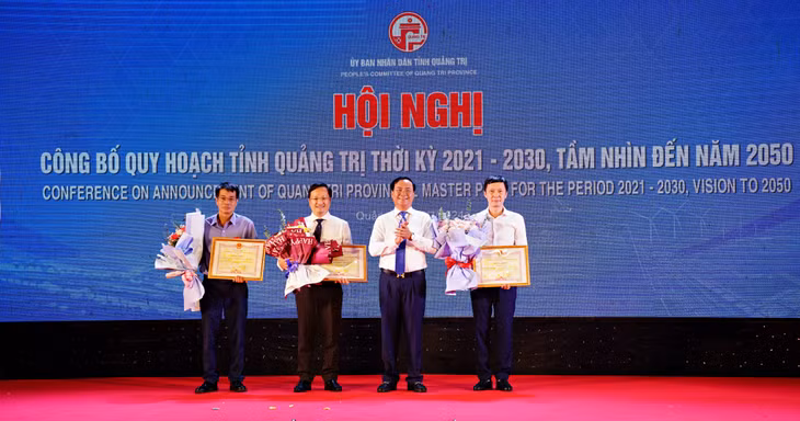 Chủ tịch UBND tỉnh Võ Văn Hưng tặng bằng khen cho các tổ chức, cá nhân có nhiều thành tích trong công tác lập quy hoạch tỉnh - Ảnh: Lê An