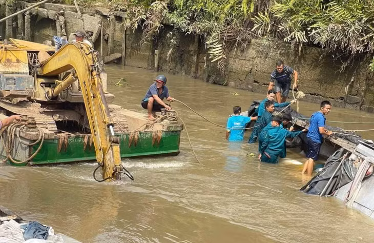 Ngành chức năng cùng người dân hỗ trợ trục vớt phương tiện và số gạo bị chìm lên bờ.