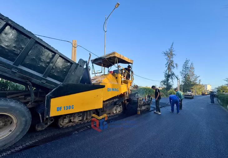 Nhà thầu thi công thảm nhựa asphalt dự án cải tạo, nâng cấp tuyến đường xuyên đảo Cô Tô. Ảnh: Mạnh Trường