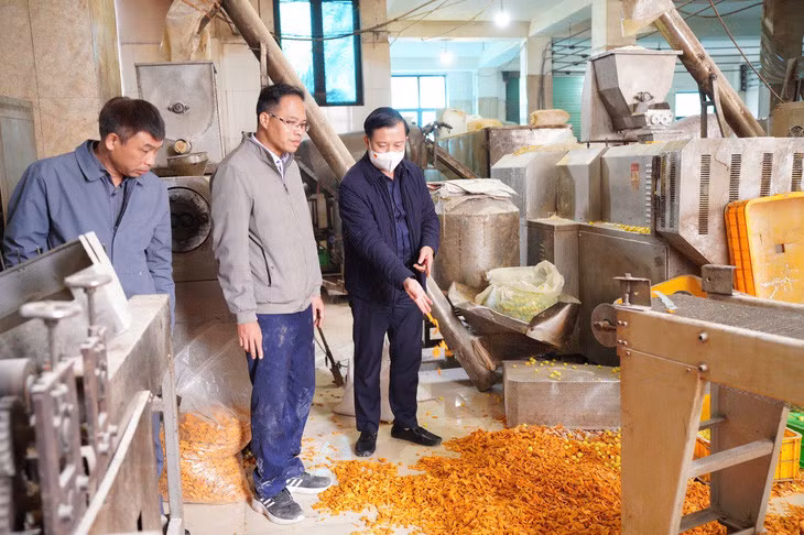 Các loại bim bim được đổ xuống sàn nhà két bẩn dầu mỡ tại cơ sở sản xuất Đức Vinh (Hà Nội) - Ảnh: T.TRANG