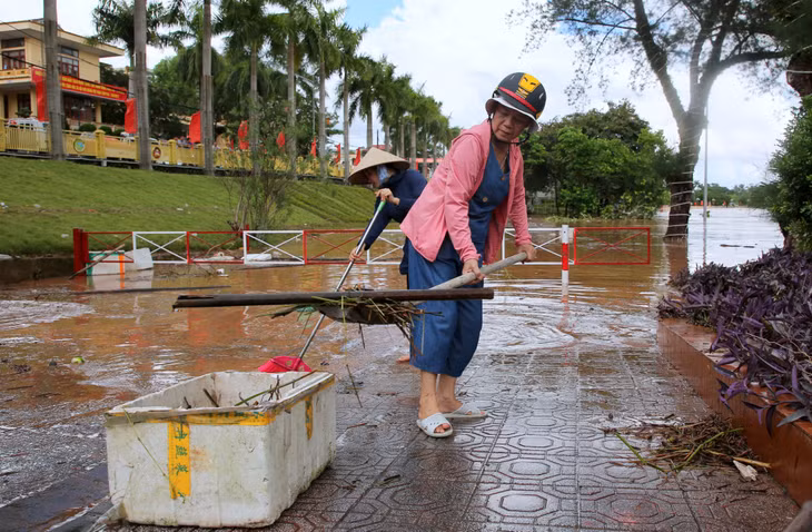 Hội viên Hội Phụ nữ thị trấn Tiên Yên dọn dẹp rác thải, cây gãy, củi mục bị lũ cuốn vào trung tâm thị trấn.