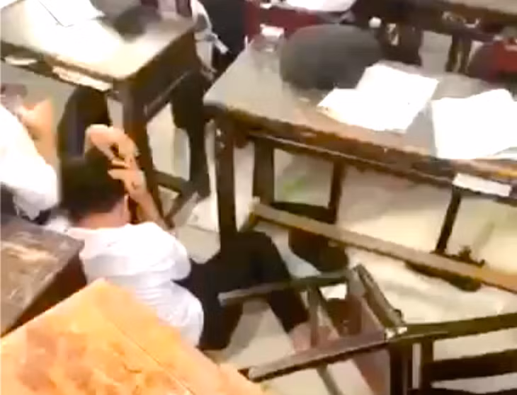 Nam sinh bị ba học sinh đánh hội đồng ngay trong lớp và phải ôm đầu chịu trận - Ảnh cắt từ clip