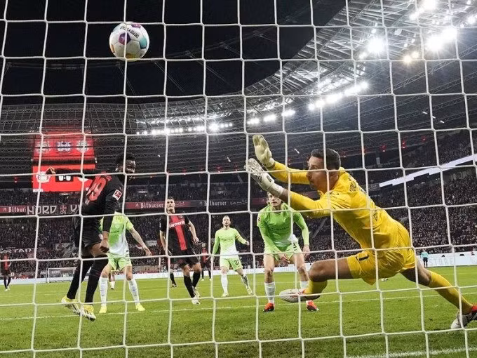 Tella (trái) ghi bàn trong trận Leverkusen 2-0 Wolfsburg ở vòng 25 Bundesliga tối 10/3 trên sân BayArena. Ảnh: AP