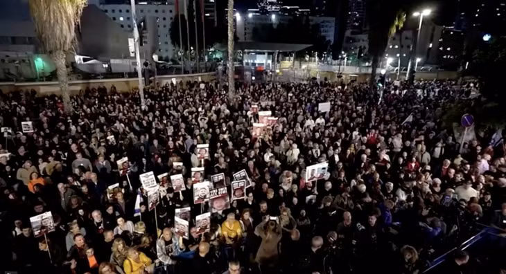 Nhiều người biểu tình Israel ở Tel Aviv tối 16/12 giơ hình ảnh con tin đang bị các tay súng Hamas giam giữ ở Dải Gaza. Ảnh cắt từ clip của Reuters