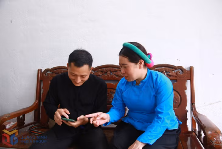 Cán bộ xã Đại Dực hướng dẫn người dân cài đặt và sử dụng các ứng dụng trên điện thoại smartphone.