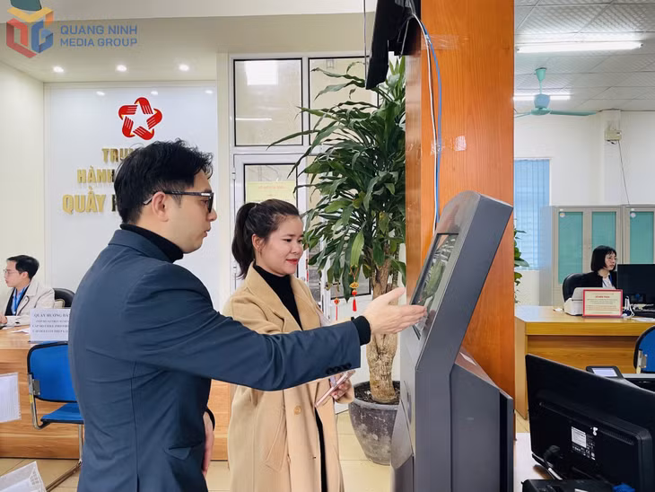 ĐVTN Chi nhánh Trung tâm Hành chính công huyện Vân Đồn hỗ trợ người dân tương tác với kiosk tự động. Ảnh: Thu Trang