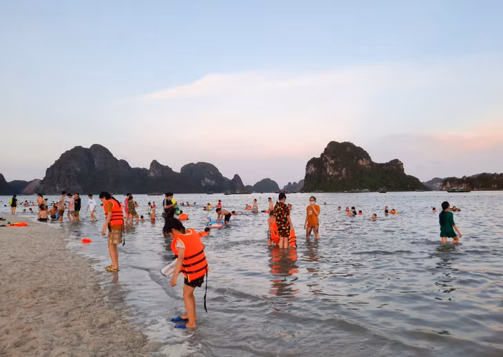 Phụ huynh cần thường xuyên kiểm soát và mặc áo phao bảo hộ cho trẻ khi tắm biển.
