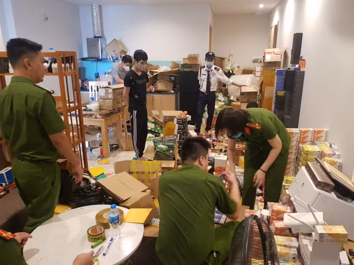 Công an TP Hạ Long thu giữ tại nhà Phan Trường Sơn (đối tượng mặc áo đen) ở Tòa A, chung cư GreenBay Garden, thuộc tổ 32, khu 2, phường Hùng Thắng, TP Hạ Long nhiều loại thuốc lá không rõ nguồn gốc vào ngày 25/8/ 2021. Ảnh Nguyễn Khánh (CTV)