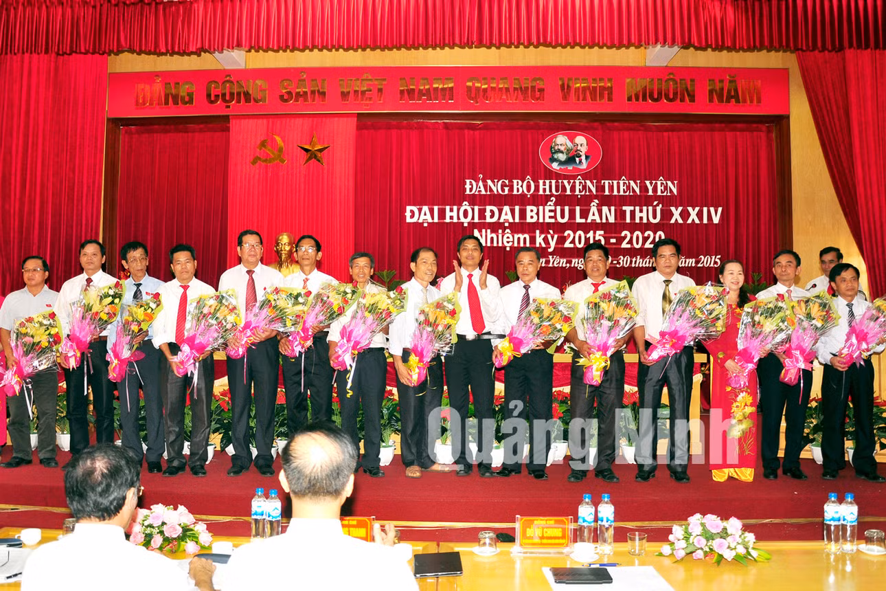 Đồng chí Vũ Văn Diện, Bí thư Huyện ủy, Chủ tịch UBND huyện Tiên Yên tặng hoa chia tay các đồng chí không tham gia Ban Chấp hành Đảng bộ huyện nhiệm kỳ 2015-2020