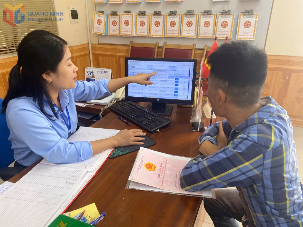 Cán bộ Chi nhánh Trung tâm Phục vụ HCC huyện hướng dẫn người dân đăng ký làm dịch vụ trên máy tính.