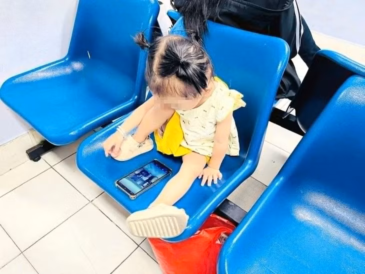Trẻ em được “ném” cho chiếc điện thoại để ngồi yên cho cha mẹ làm việc là hình ảnh không quá hiếm và có thể bắt gặp ở bất cứ đâu - Ảnh: TH.DƯƠNG